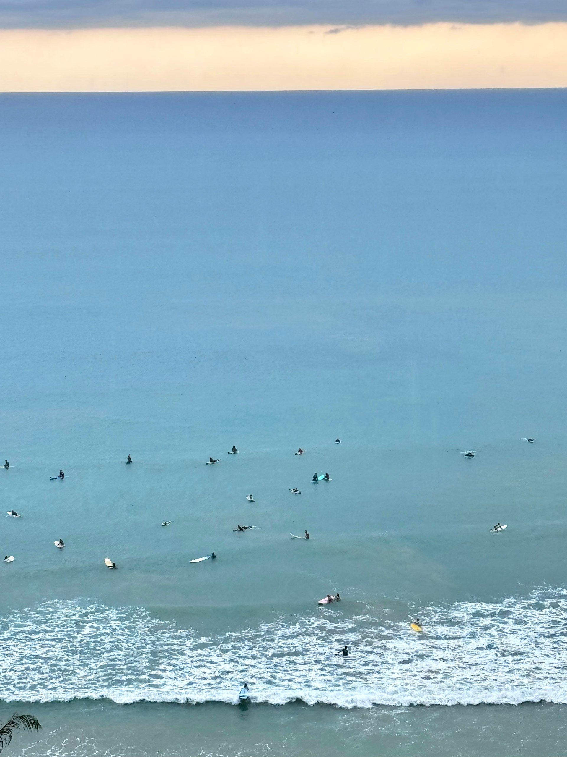Beginner surfers waiting for waves in a calm bay