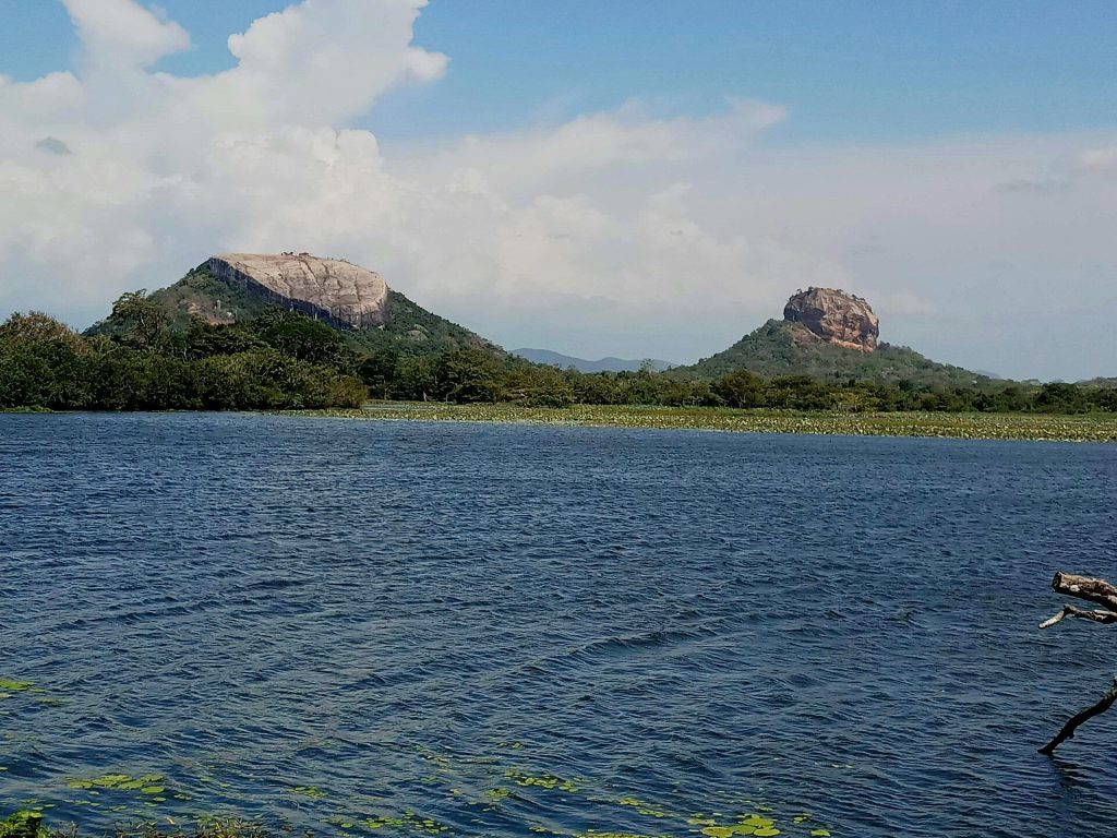 Sigiriya Rock and Pidurangala Rock seen across a lake