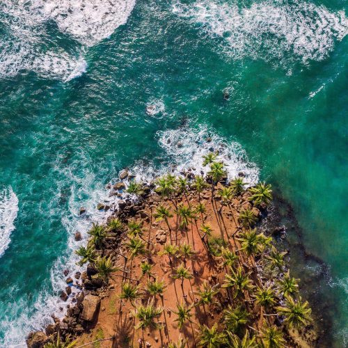 Aerial view of Coconut Tree Hill and turquoise sea in Mirissa, Sri Lanka