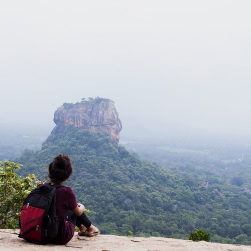 Hiker looking at Sigiriya from the top of Pidurangala Rock