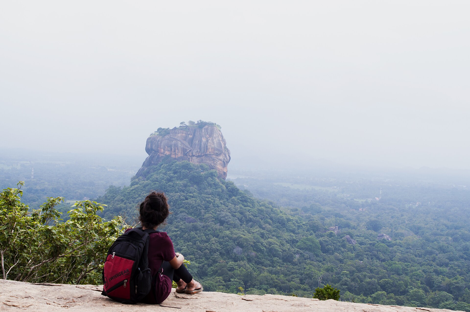 Hiker looking at Sigiriya from the top of Pidurangala Rock